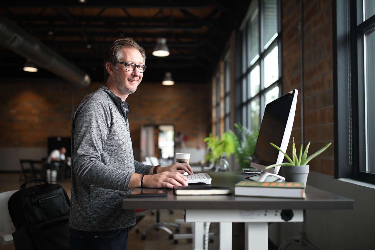 Ergonomic office setup with adjustable standing desk. Ergonomic office setup with adjustable standing desk.