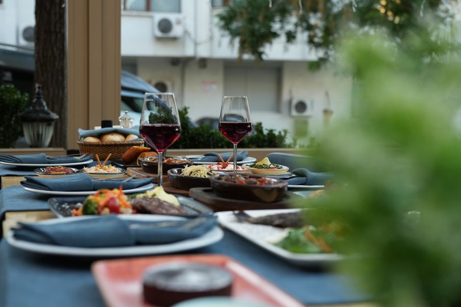 Outdoor dinner party with stylish cooling fans. Outdoor dinner party with stylish cooling fans.