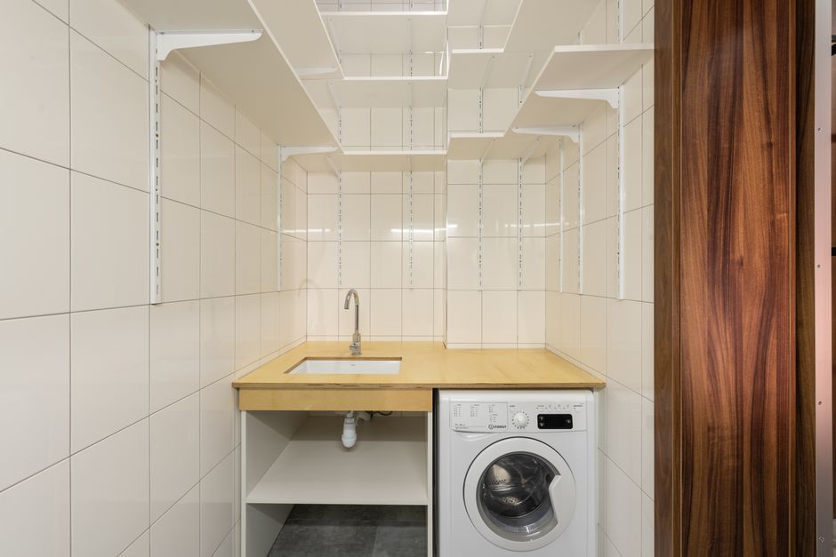 Bright utility room with organized workspace and cabinets.