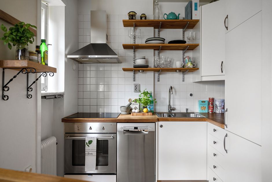 Small kitchen with vertical storage shelves. Small kitchen with vertical storage shelves.
