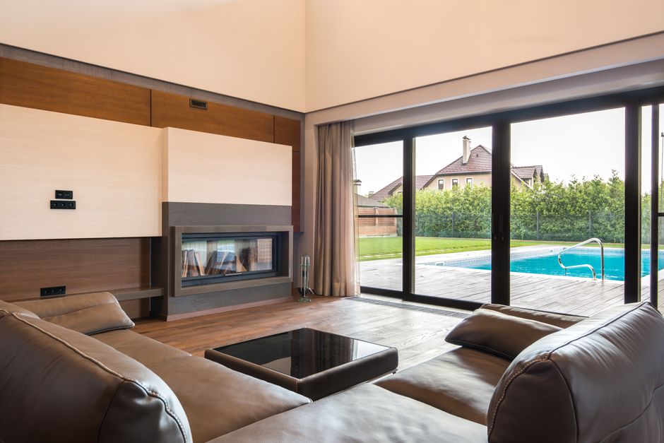 Elegant glass sliding doors connect garden and living space Elegant glass sliding doors connect garden and living space