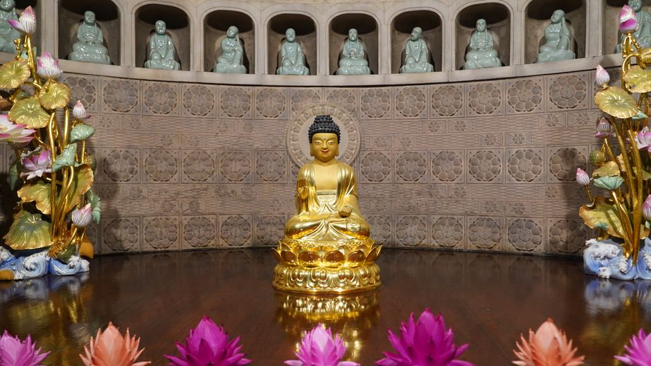 Buddha statue at garden entrance with lanterns. Buddha statue at garden entrance with lanterns.