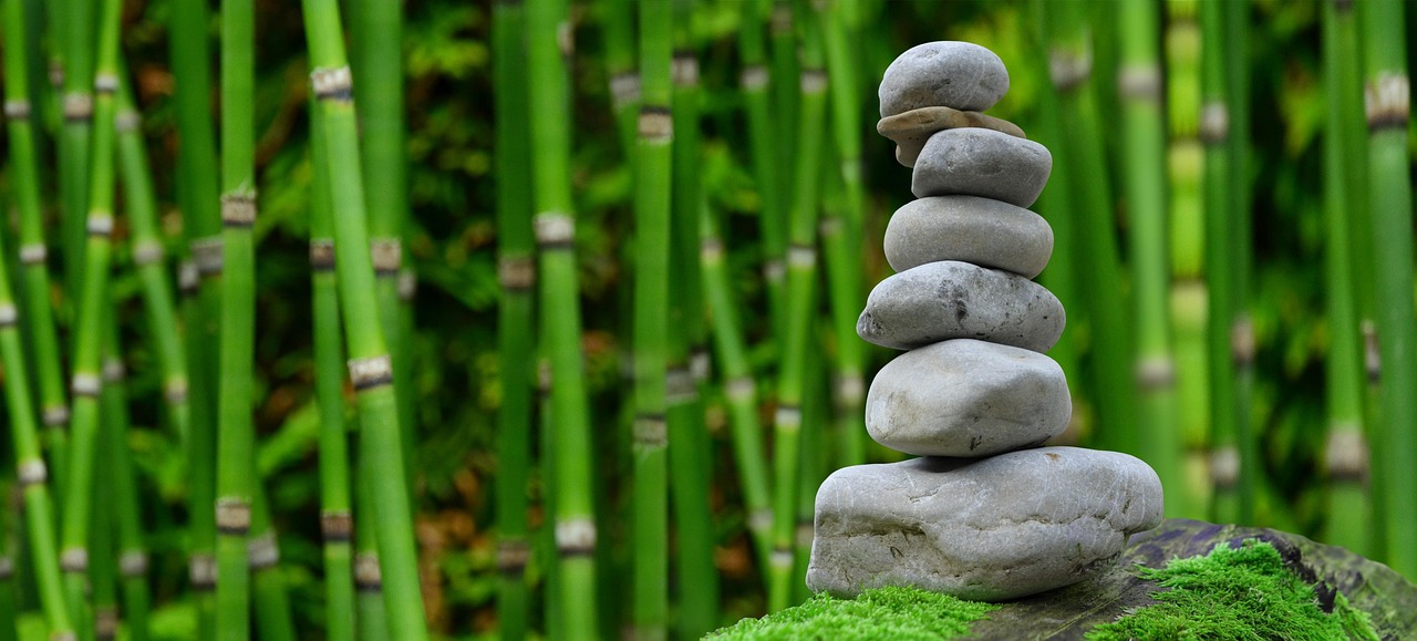 Elegantly carved Zen sculpture amid lush greenery. Elegantly carved Zen sculpture amid lush greenery.
