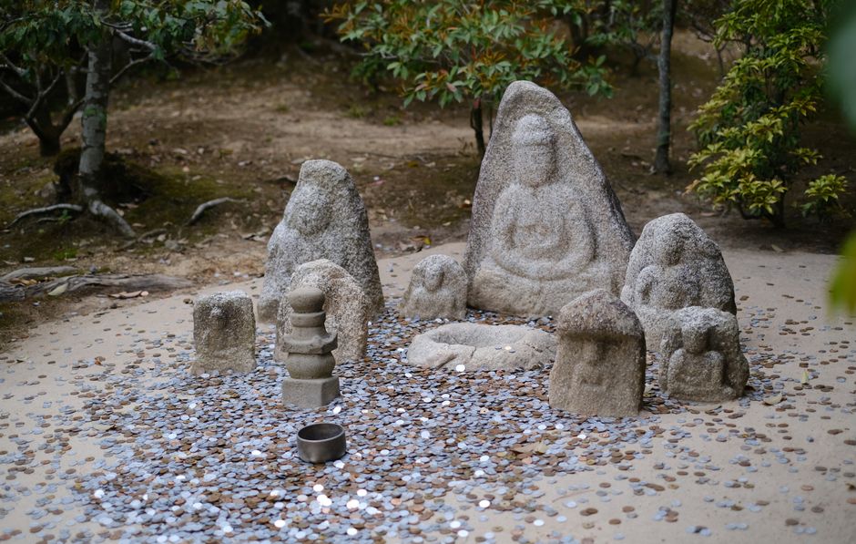 Stone Buddha statue in tranquil garden setting. Stone Buddha statue in tranquil garden setting.